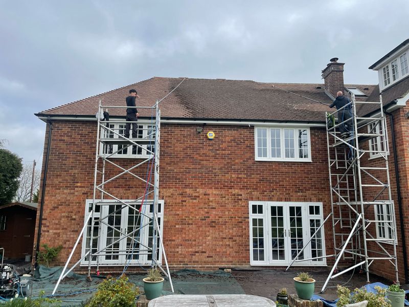 Roof cleaning carried out safely from scaffold towers by The Roof Moss Cleaners in Farnham